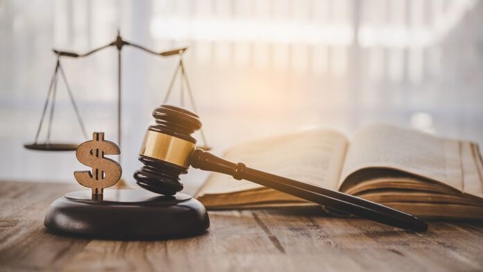 Law and justice concept. Judge hammer with the dollar placed - c